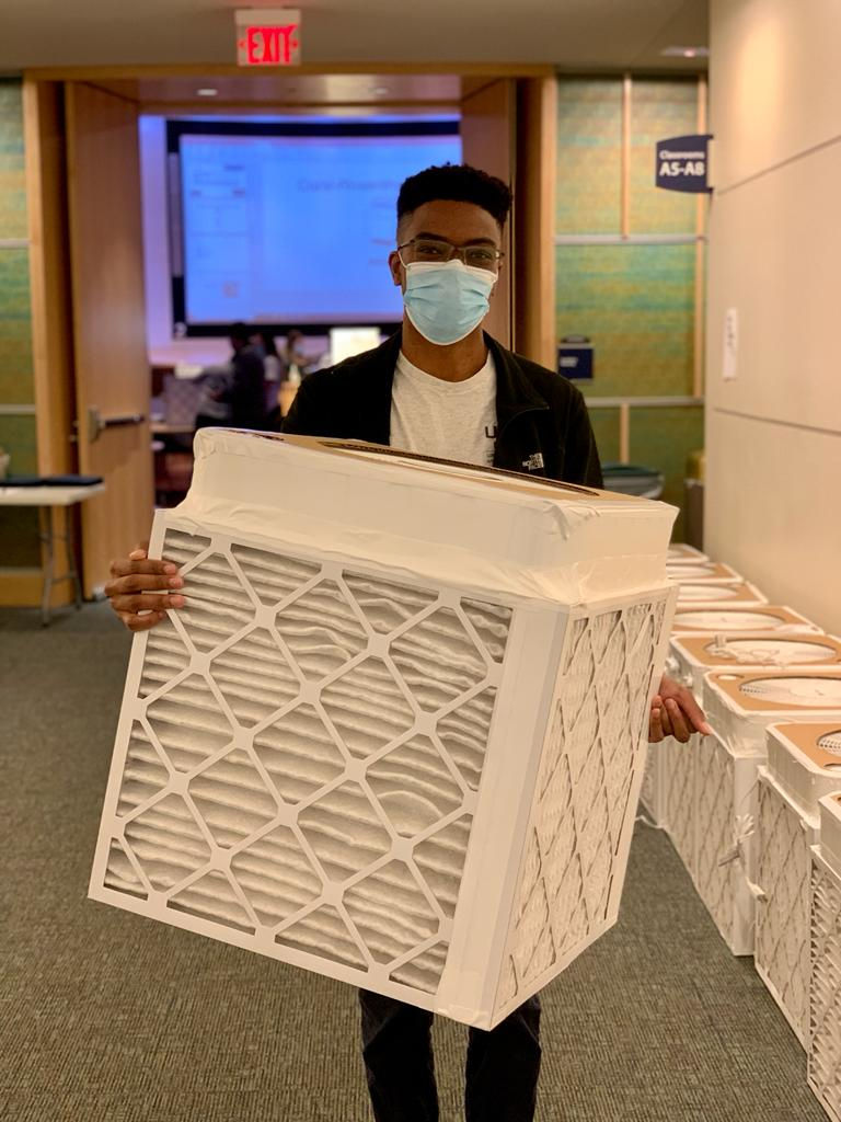 male student carrying DIY air filter photo