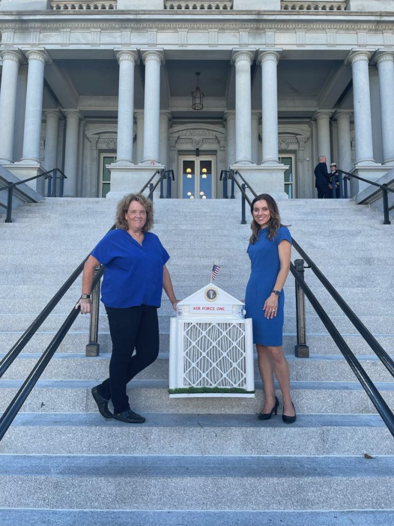 two females with air filter at white house
