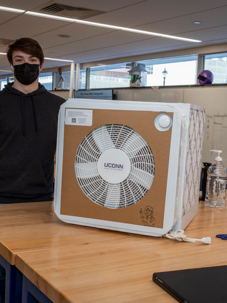 student standing aside air filter